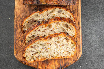Grain bread sunflower, chia, flax seed, cut oats fresh tasty food dish delicious gourmet food background on the table rustic food top view copy space vegetarian and vegan food