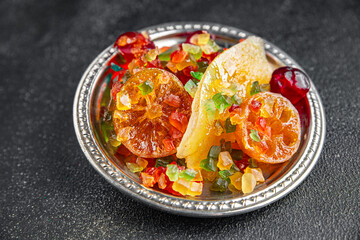 Candied peel and fruit orange, kumquat, tangerine, cherry, mango and others Sugar-coated fruit fresh tasty food dish delicious gourmet food background on the table rustic food top view copy space