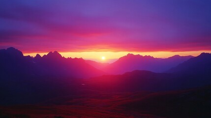 Obraz premium Vibrant Pink And Purple Sunset Over Silhouetted Mountains