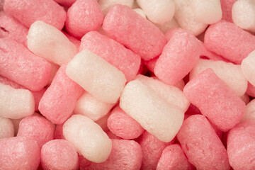 Pink and white box filler as a background. Top view.