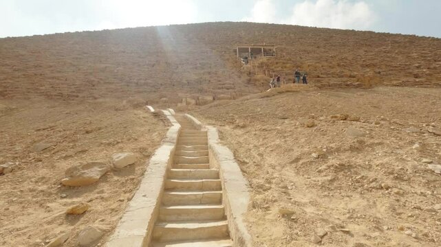 Tourists ascending the bent pyramid of sneferu at dahshur