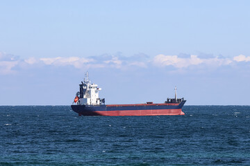 Large cargo ship above the horizon line.