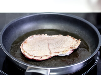Frying beef fillets in the pan.
