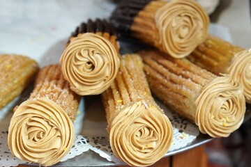 typical spanish sweet, porras filled with sweet cream and sugar sprinkled on top.