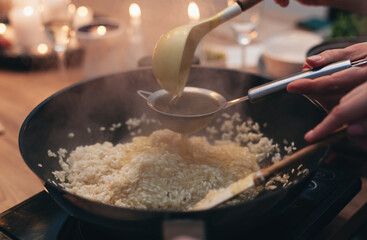 the process of cooking risotto in a frying pan