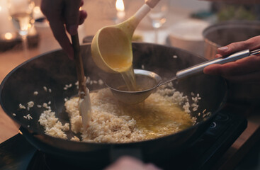 the process of cooking risotto in a frying pan