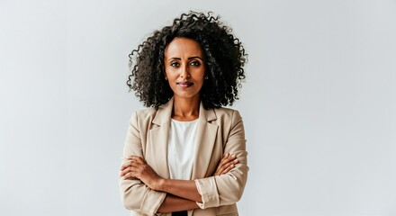 A professional Ethiopian woman in a beige blazer stands with a determined expression, representing empowerment, success, and career growth. Perfect for business, finance, and leadership themes.