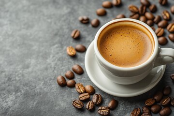 Fototapeta premium A cup of hot espresso and coffee beans on a grey background