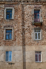 Fragment of old building with balcony and windows