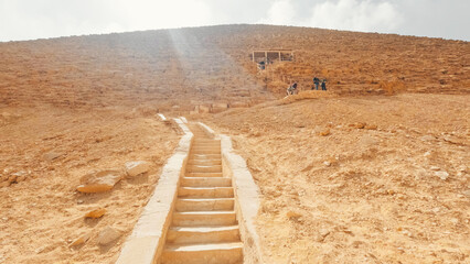 Tourists climbing the bent pyramid of sneferu in dahshur, egypt