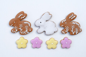 Easter gingerbread cookies in a shape of bunny and flowers, white background