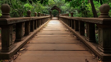 Obraz premium A serene wooden bridge leads through lush greenery, creating a tranquil path perfect for nature lovers or travel enthusiasts seeking a peaceful getaway