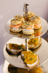 Assorted elegant snacks served on a tiered stand at a sophisticated gathering during a festive afternoon