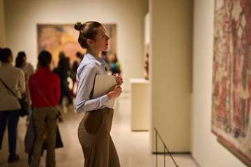 visitor in historical museum looking at art object