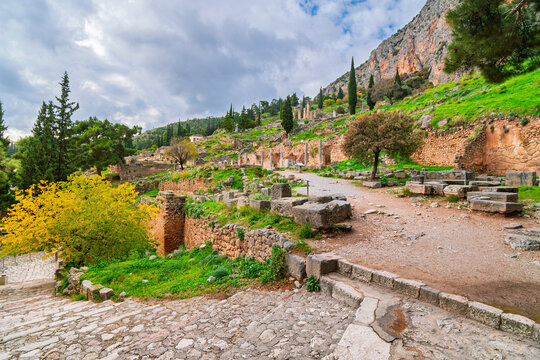 Ancient roads past temples and ruins at the ancient sanctuary of the Oracle and site of the Temple of Athena, at the archaeological site of Delphi Greece.