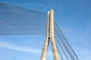 Obraz premium High Suspension Bridge Tower with Cables Against Clear Blue Sky
