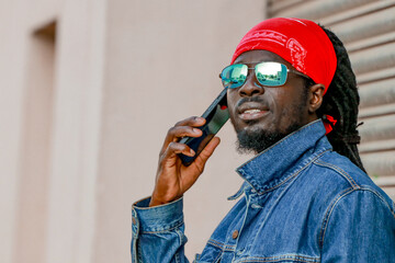 black young man with mobile phone on street