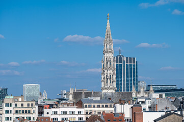 Fototapeta premium Town hall gothical tower and contemporary finance tower in the background, high angle view of Brussels old town, Brussels Capital Region, Belgium. March 16, 2025