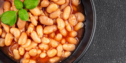 White bean tomato sauce gourmet food background on the table rustic food top view copy space