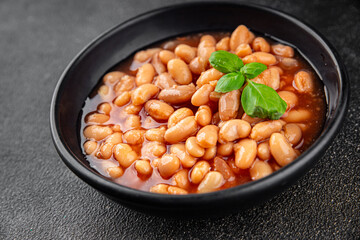 White bean tomato sauce gourmet food background on the table rustic food top view copy space