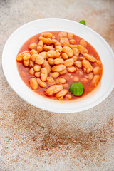 White bean tomato sauce gourmet food background on the table rustic food top view copy space