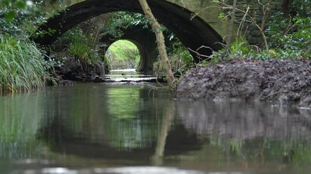 Liley Brook Stream Flowing Under Arched Bridge near Cox&rsquo;s Meadow, Cheltenham, UK