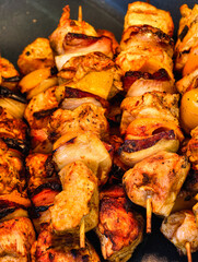 Grilled chicken kebabs with vegetables, homemade BBQ skewers, fresh marinated meat and bell peppers closeup. Vertical stock photography 