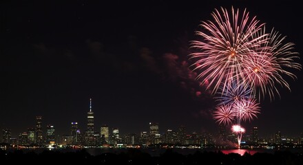 Fireworks illuminate the night sky over a vibrant city skyline, creating a festive atmosphere of celebration and excitement