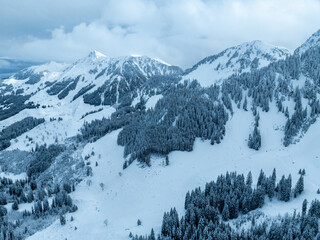Obraz premium Aerial view of Gantrisch mountains in Swiss alps. Tranquil snow covered landscape.