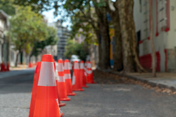 Coneheads reserve streets in a city for vehicles not to park, area for film trucks.
