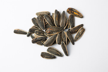 Sunflower seeds piled on a white background: ready for snacking