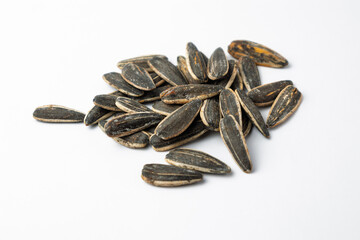 Sunflower seeds piled on a white background representing healthy snacking