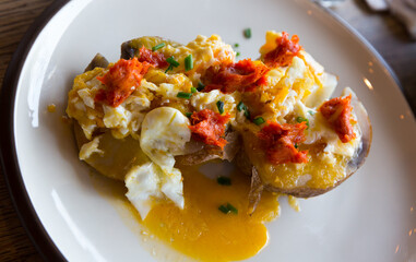Baked al caliu potatoes with sobrassada and fried eggs. Traditional Spanish cuisine