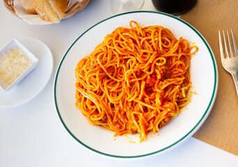 Italian bolonesa, bolognese noodles with tomato sauce and cheese in a cafe