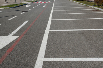 Parallel white stripes alternate with red to increase visibility. A universal urban symbol of mobility and road safety, crosswalks connect opposing sidewalks in cities around the world.