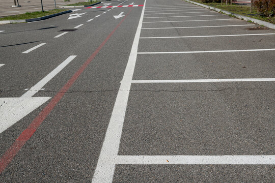 Parallel white stripes alternate with red to increase visibility. A universal urban symbol of mobility and road safety, crosswalks connect opposing sidewalks in cities around the world.