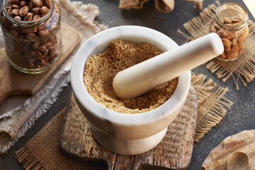 Preparation of homemade hazelnut butter in a white marble mortar