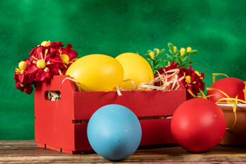 eggs in wooden box with hay on rustic background or surface, easter or holiday concept