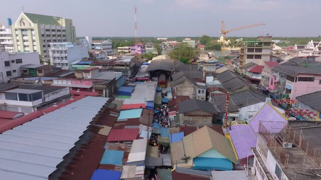 Drone perspective of busy Maeklong Railway Market in Samut Songkhram, Thailand. Aerial drone video