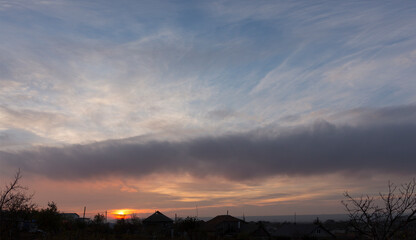 Obraz premium Landscape at sunset. Tragic gloomy sky. Panorama. Crimson twilight.