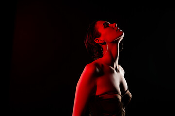 Photo of stunning hot young woman sensual posing neon red light dressed trendy dress on black color...