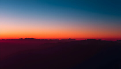 Obraz premium Vibrant Sunset over Majestic Mountain Range Aerial View