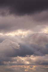large white thunderclouds with bright rays of sunlight breaking through them