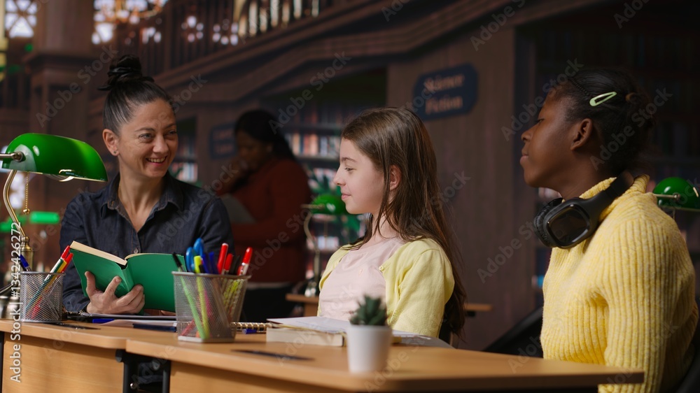 Poster elementary students receiving support from a tutor working on homework assignments in a diverse lear