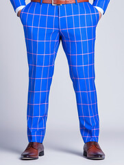clothing: bright blue trousers with windowpane plaid, with brown shoes