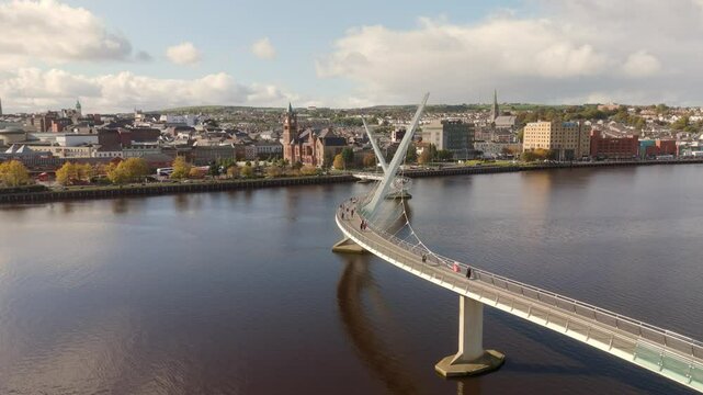City of Derry aka Londonderry in Northern Ireland aerial view - A Beautiful Cityscape from above by the River Foyle Featuring the Beautiful Pedestrian Peace Bridge
