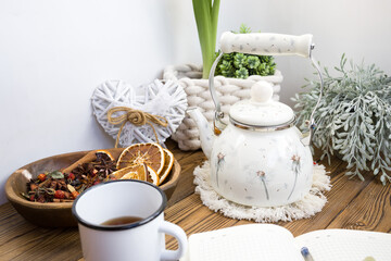 Enameled teapot with gooseberries, cranberries and cinnamon sticks. Spicy aromatic tea