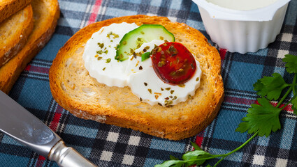 Toast with soft cheese, cucumber and cherry tomato