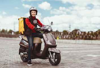 Food Delivery. Courier Guy Delivering Restaurant Meals In Box, Posing On Motorbike Outdoors. Empty Space For Text © Prostock-studio