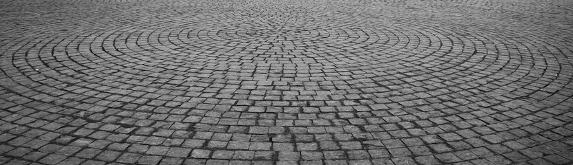 paving stone texture. Stone pavement texture in perspective. Abstract background of old cobblestone pavement. round Backdrop texture of paving slabs in circles.
